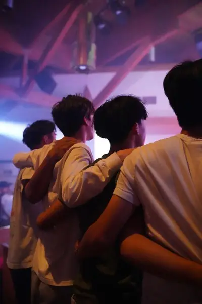 Students worshipping arm in arm