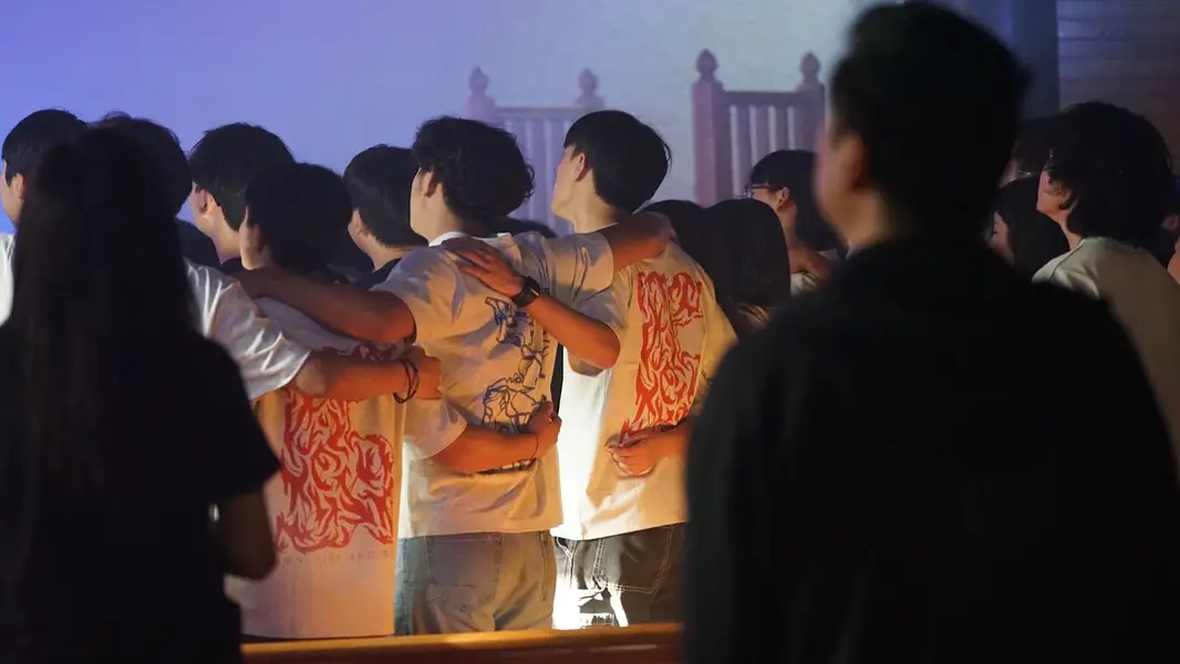 Students with arms around each other in Fire & Water shirts